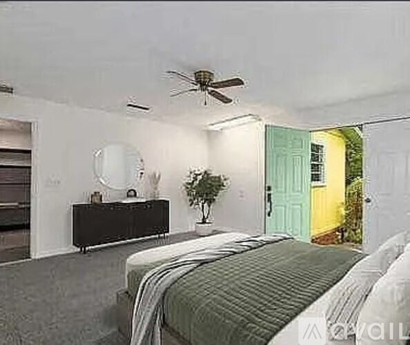 A bedroom with a bed, dresser, and ceiling fan.