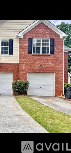 A red brick house with a white garage door.