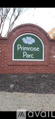 A green sign that says Primrose Parc on a brick wall.