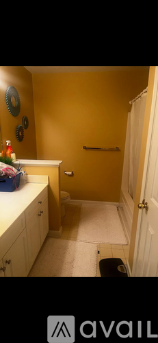 A bathroom with yellow walls and a white door.