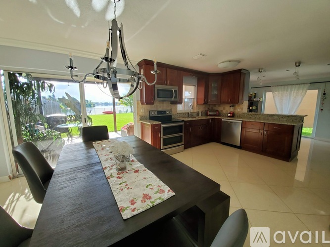 A modern kitchen with a long table and chairs.