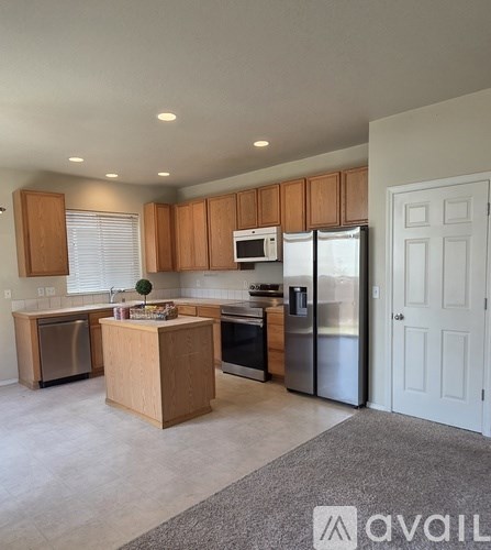 A kitchen with wooden cabinets and stainless steel appliances.
