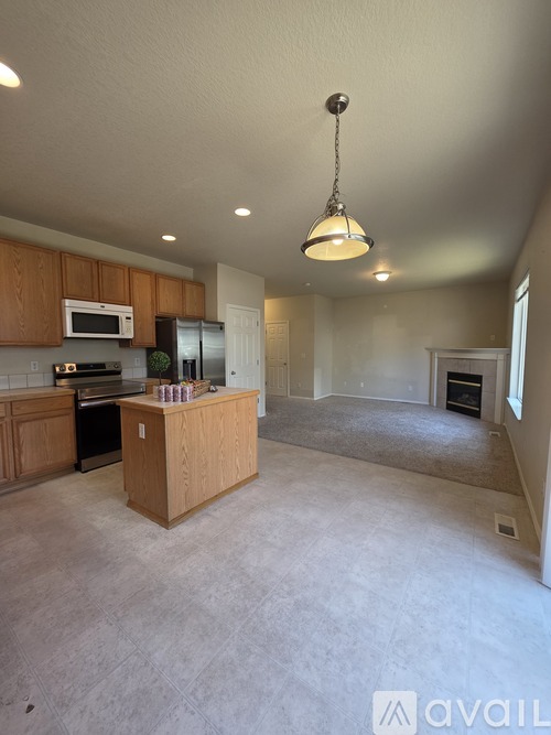 A kitchen with wooden cabinets and a central island.