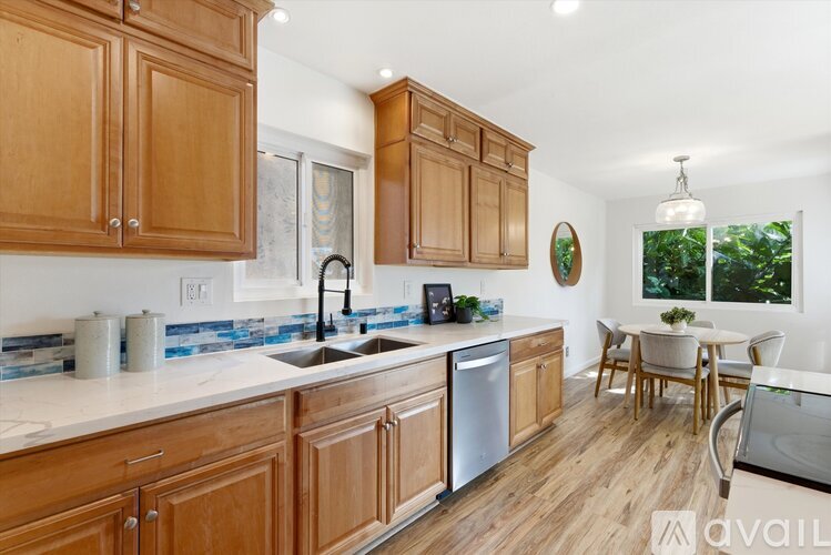 A kitchen with wooden cabinets and a white countertop.
