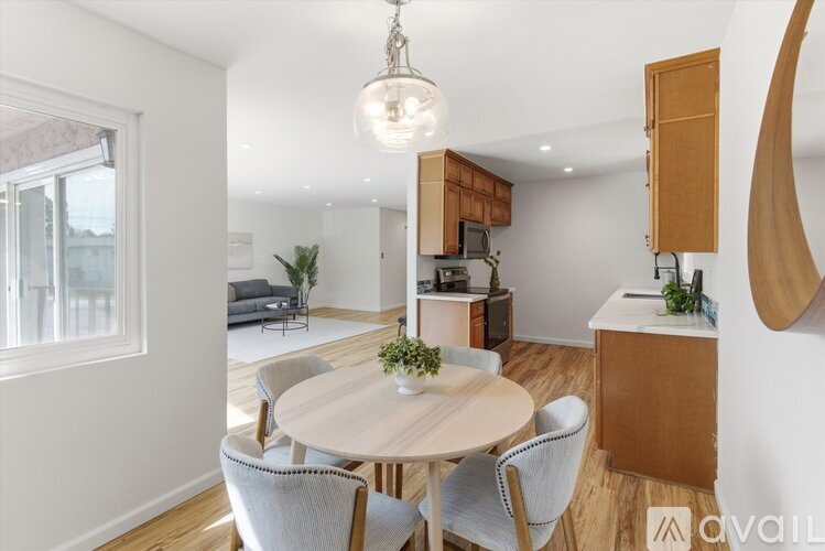 A modern dining room with a round table and chairs.