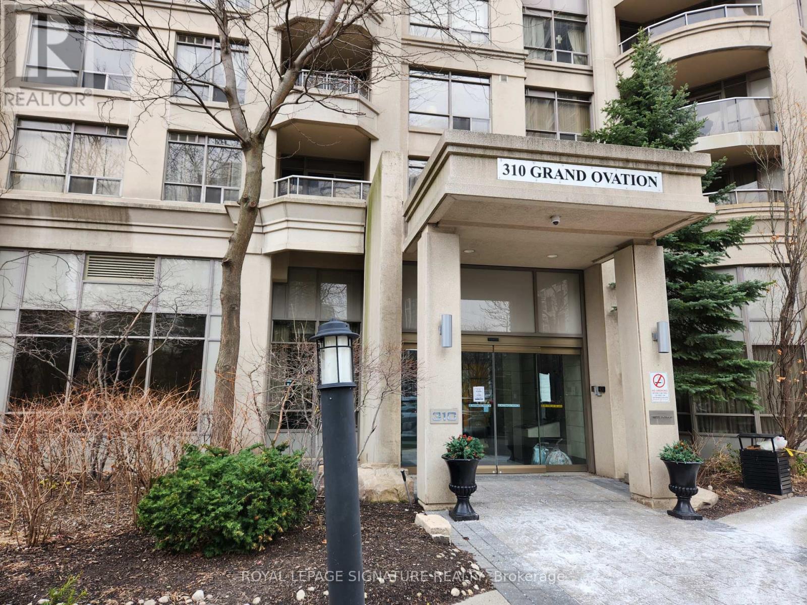The entrance to a building with a sign that reads "310 Grand Ovation".
