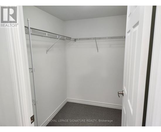 A white bedroom with a white door and a white wall.