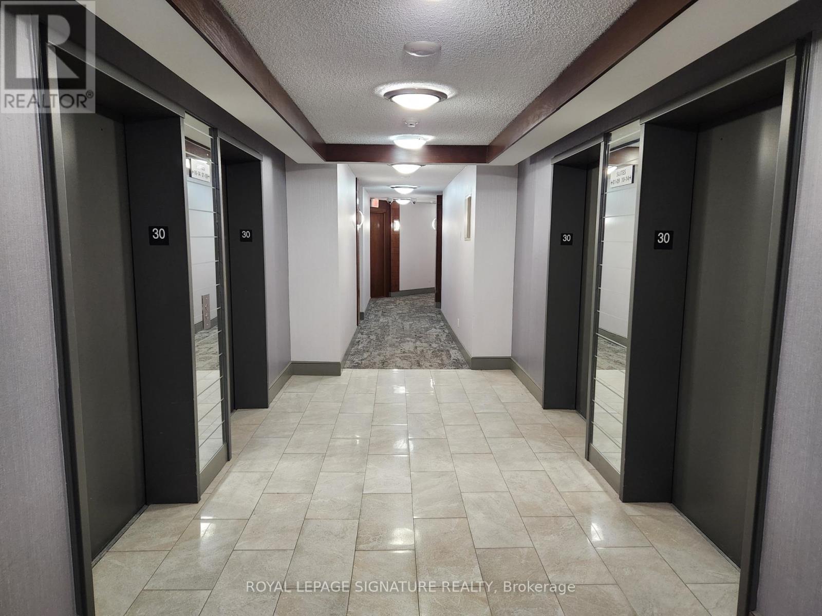 A hallway with elevator doors numbered 30.