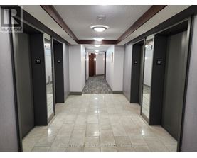 A hallway with elevator doors numbered 30.