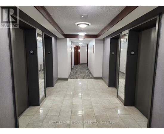 A hallway with elevator doors numbered 30.