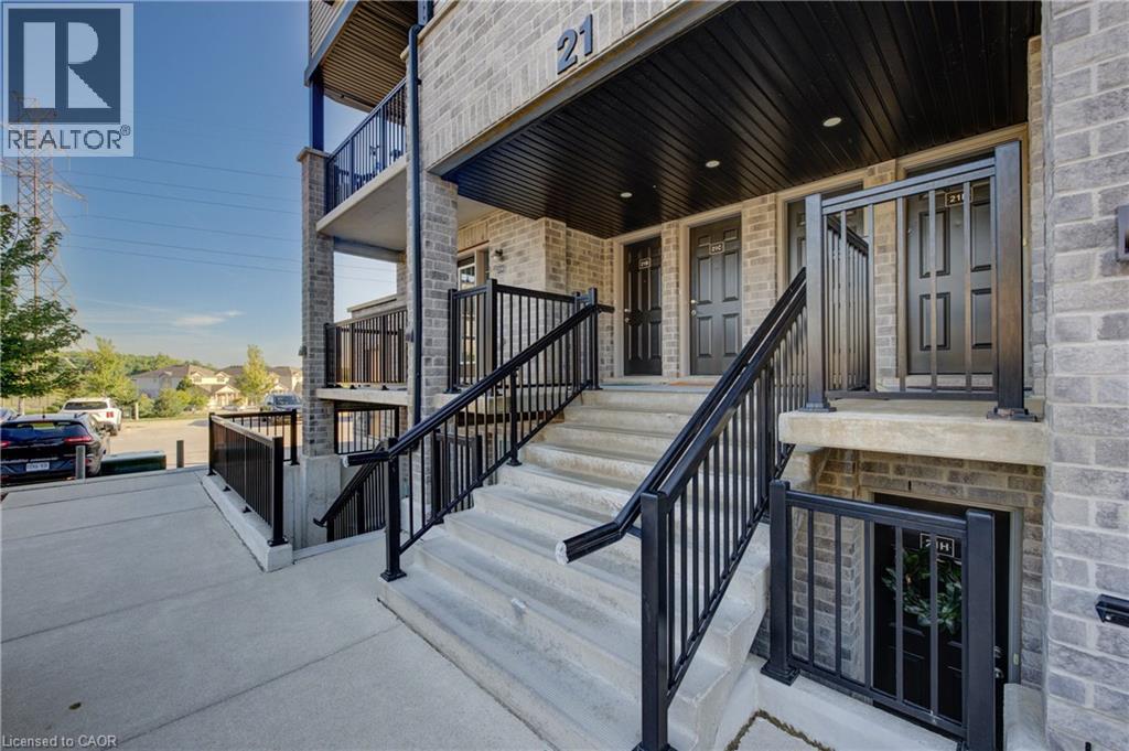 A building with a black railing and steps leading to a door.