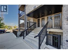 A building with a black railing and steps leading to a door.