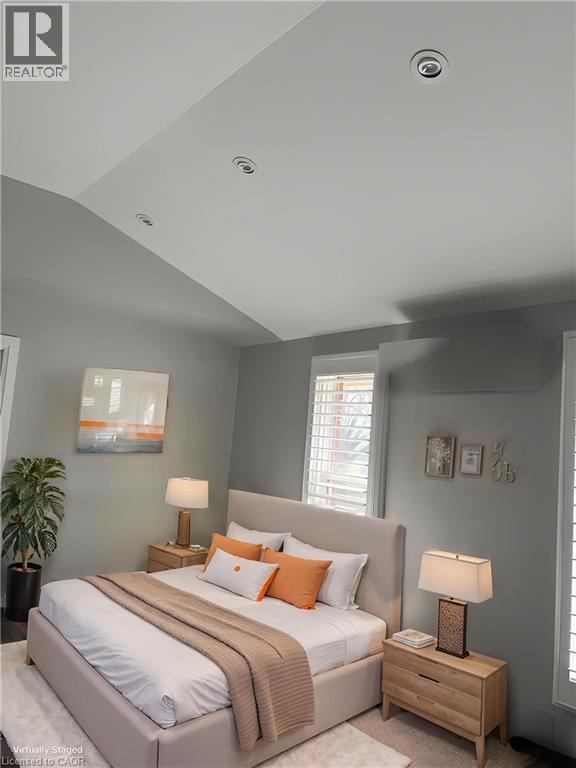 A bedroom with a large bed and a lamp on the nightstand.