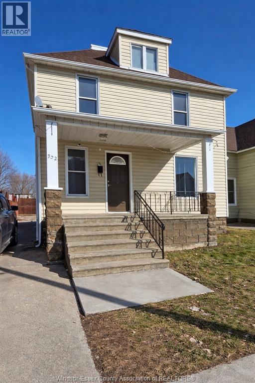 A two-story house with a front porch and a garage.