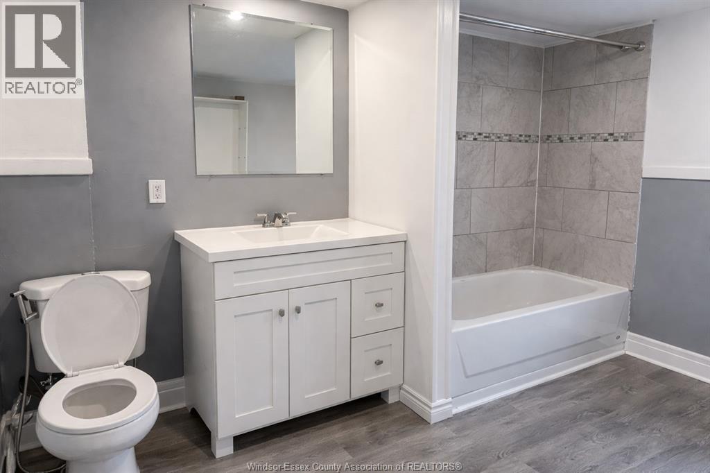 A white toilet sits next to a sink in a bathroom.