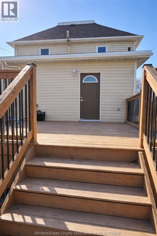A house with a brown door and a small porch.
