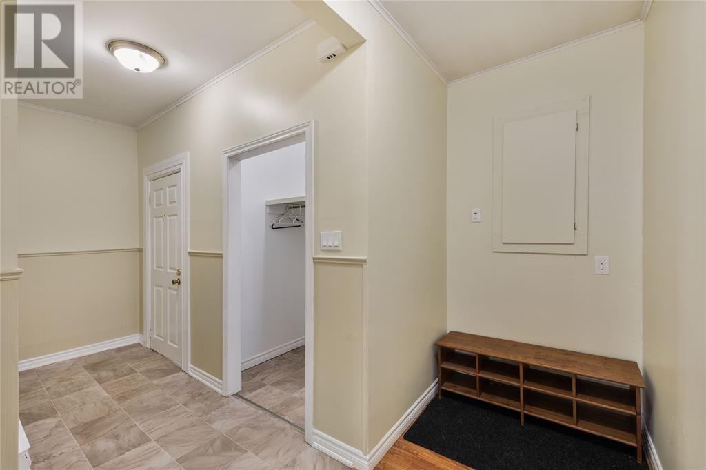 A room with a bench and a door.