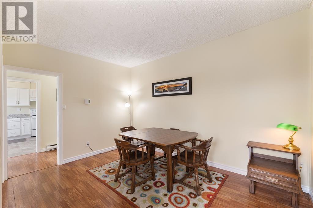 A dining room with a wooden table and chairs.