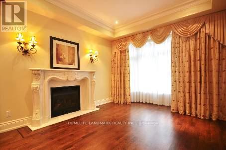 A living room with a fireplace and a painting on the wall.