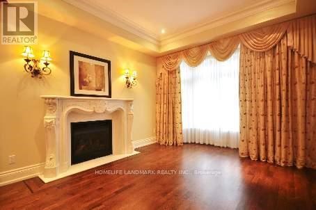 A living room with a fireplace and a painting on the wall.