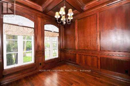 A room with wood paneling and a chandelier.