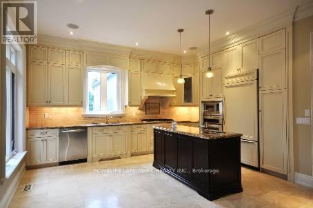 A kitchen with a black countertop and white cabinets.