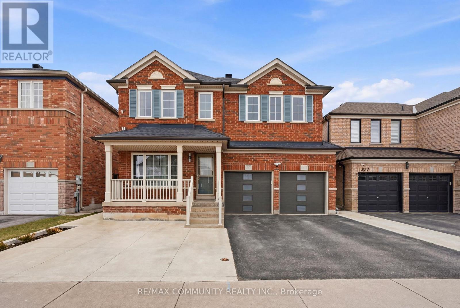 A brick house with a garage is for sale.