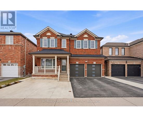 A brick house with a garage is for sale.