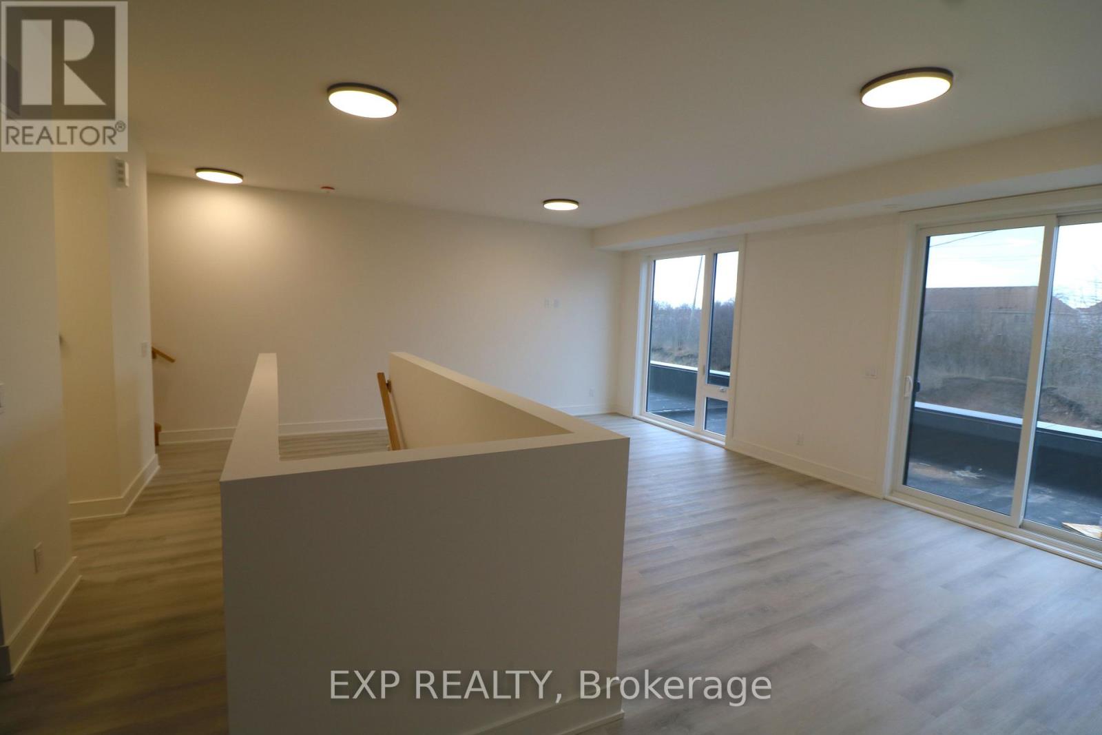 A realtor's office with a large white box in the middle of the room.
