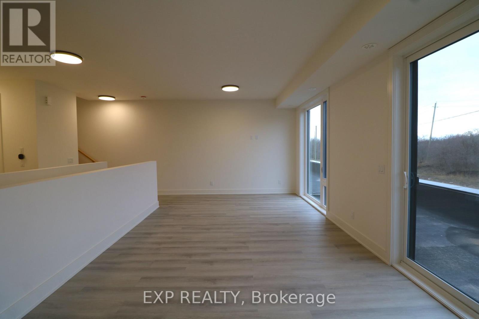 A room with EXP REALTY, Brokerage written on the floor.