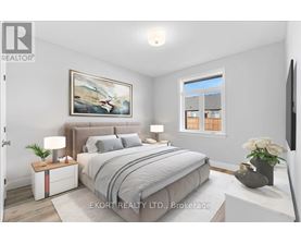 A bedroom with a large bed, a nightstand with a lamp, and a painting on the wall.