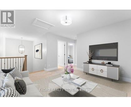 A living room with a grey sofa, a coffee table, and a television on a cabinet.