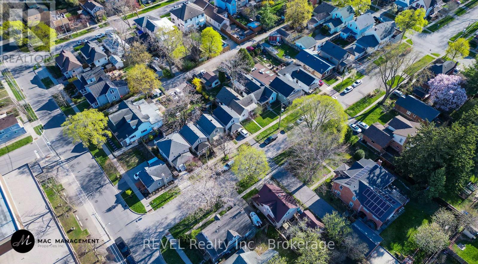 A bird's eye view of a residential neighborhood with houses and trees.