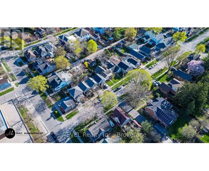 A bird's eye view of a residential neighborhood with houses and trees.