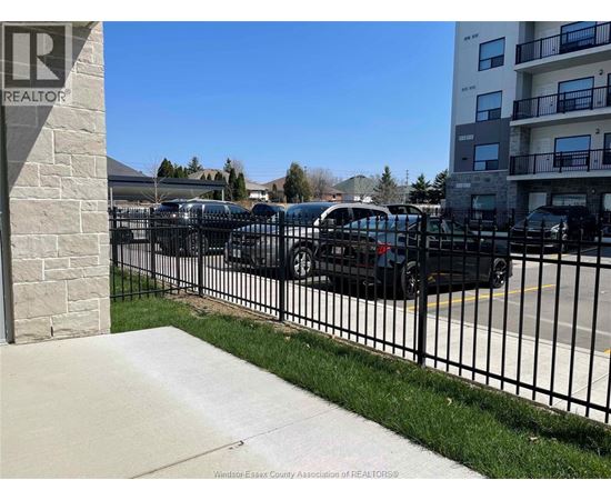 A parking lot with cars and a sign that says REALTOR.