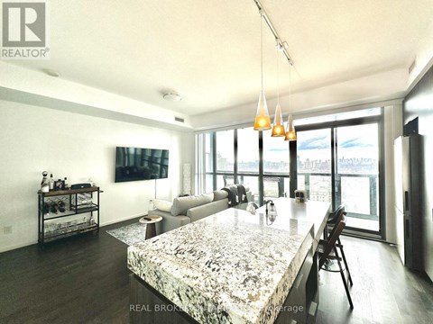 A modern living room with a marble table and a view of the city.