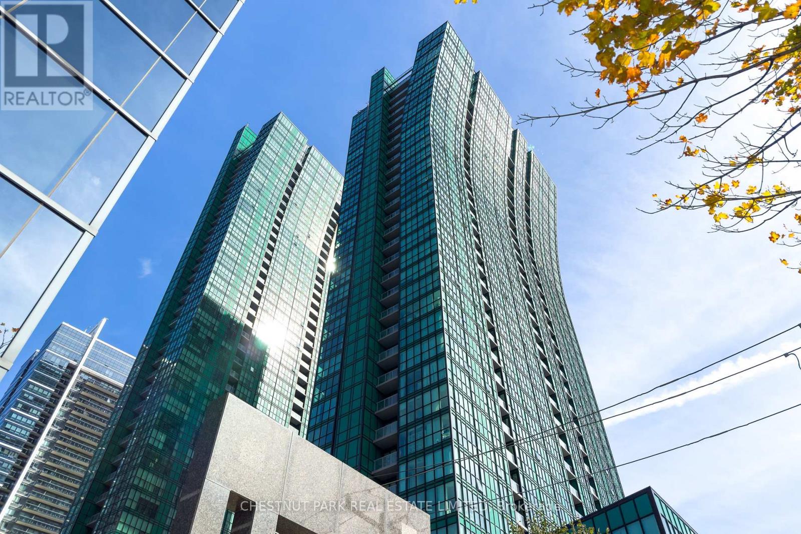 A tall building with many windows is seen in the image.