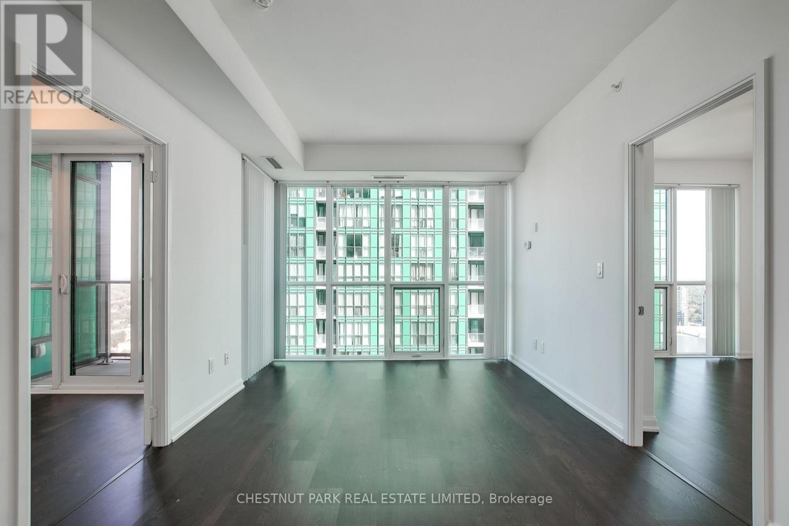 A large empty room with a glass block window.
