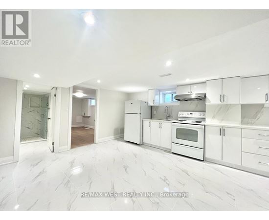 A white kitchen with a marble floor and white cabinets.