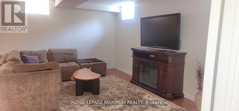 A living room with a large couch and a television.