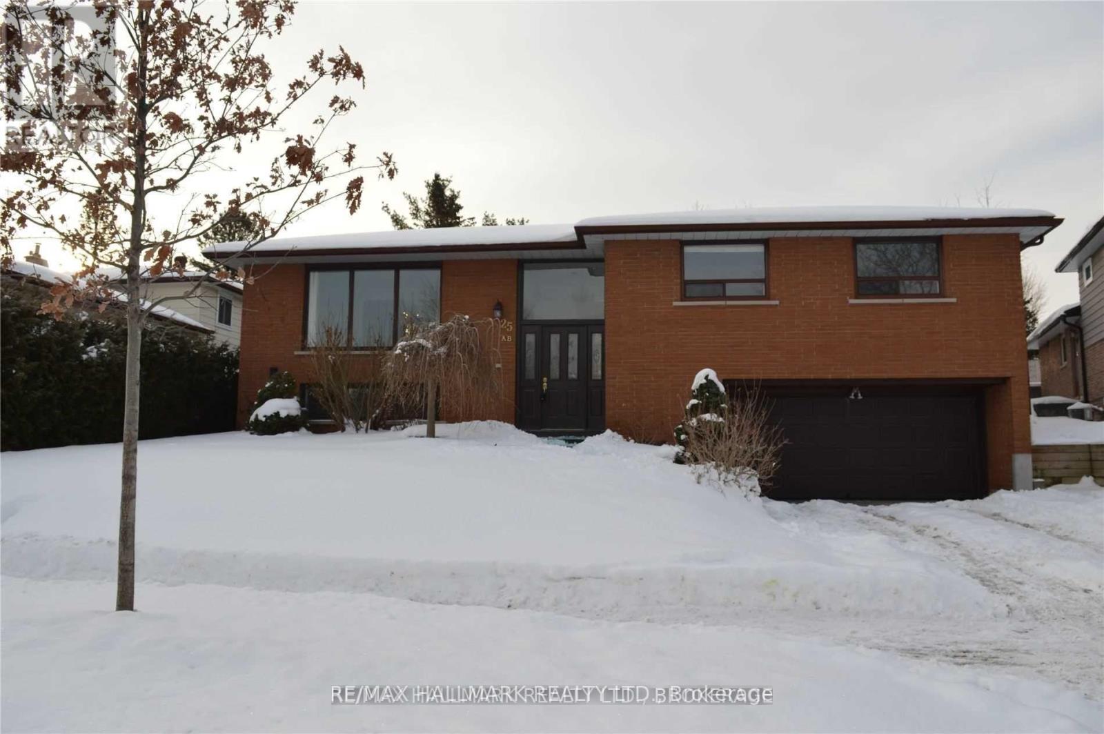 A house with a snow-covered ground in front.