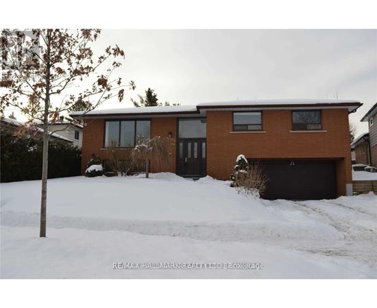 A house with a snow-covered ground in front.