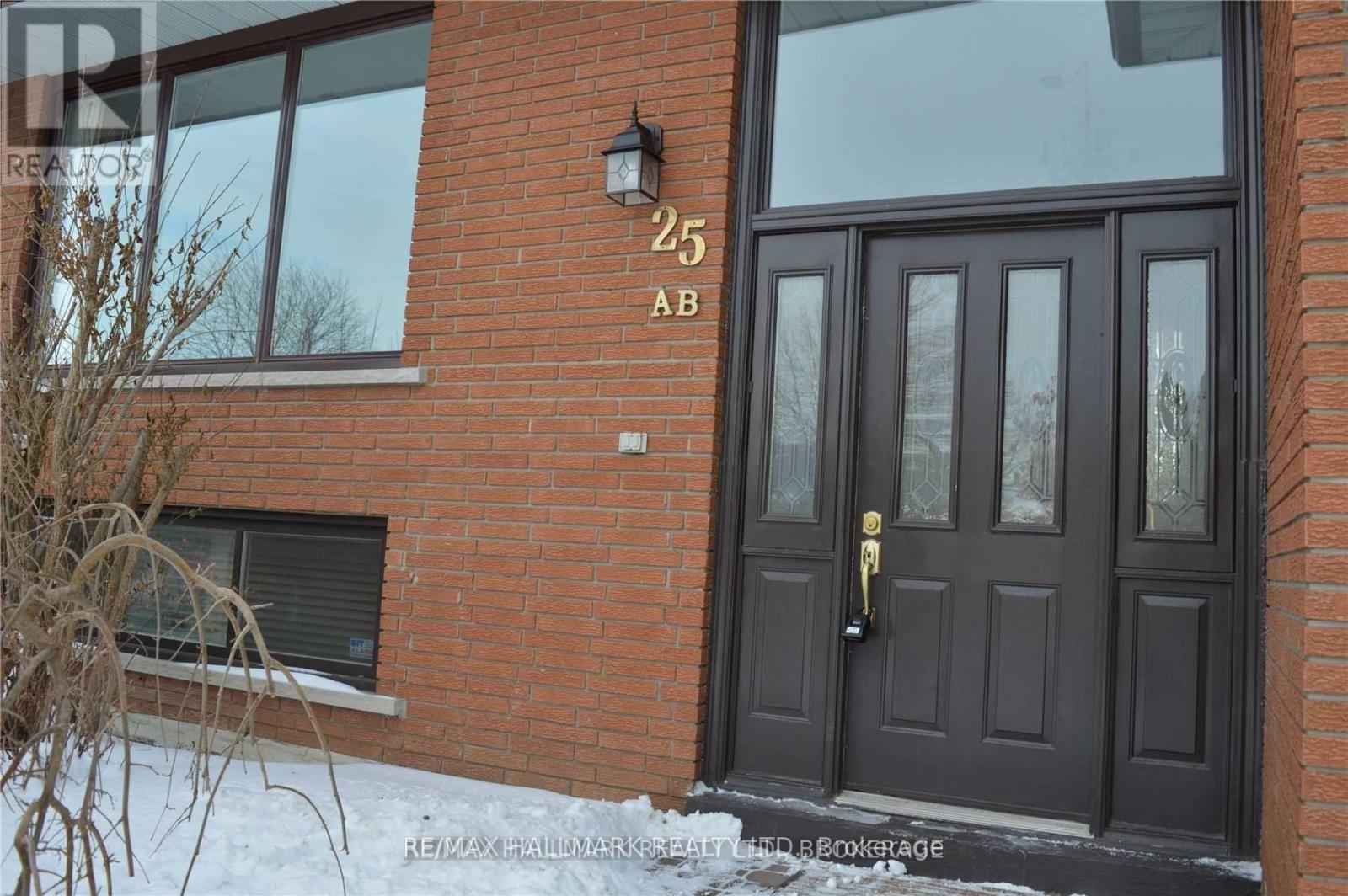 A brown door with a black handle and a number 25 on the wall above it.