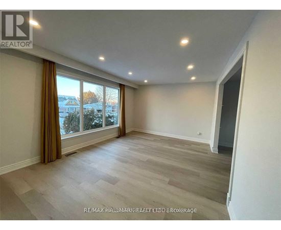 A spacious room with a large window and a view of the outdoors.