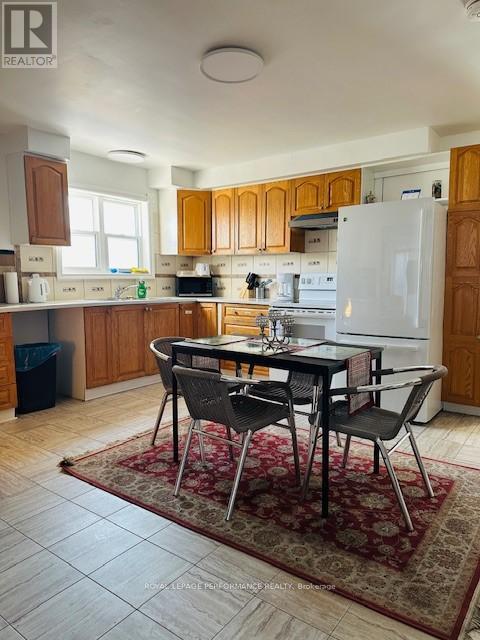 A kitchen with a table and chairs in the middle of the room.