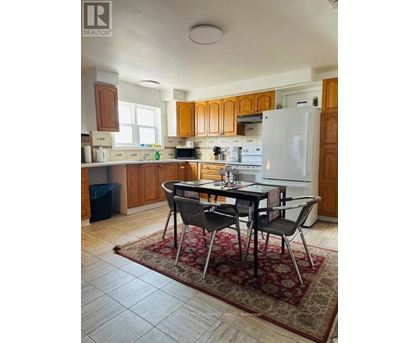 A kitchen with a table and chairs in the middle of the room.
