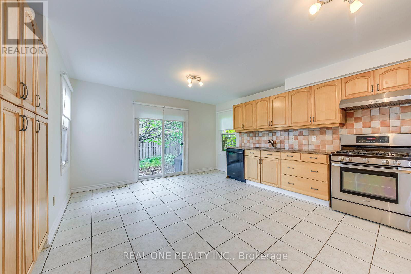 A kitchen with a stove top oven and a dishwasher.