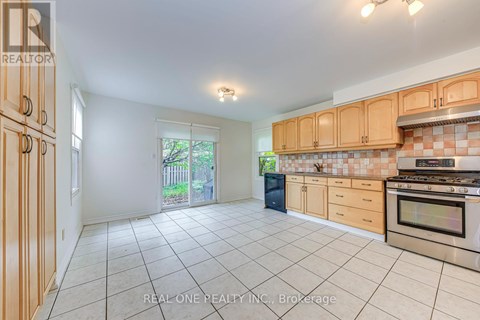 A kitchen with a stove top oven and a dishwasher.