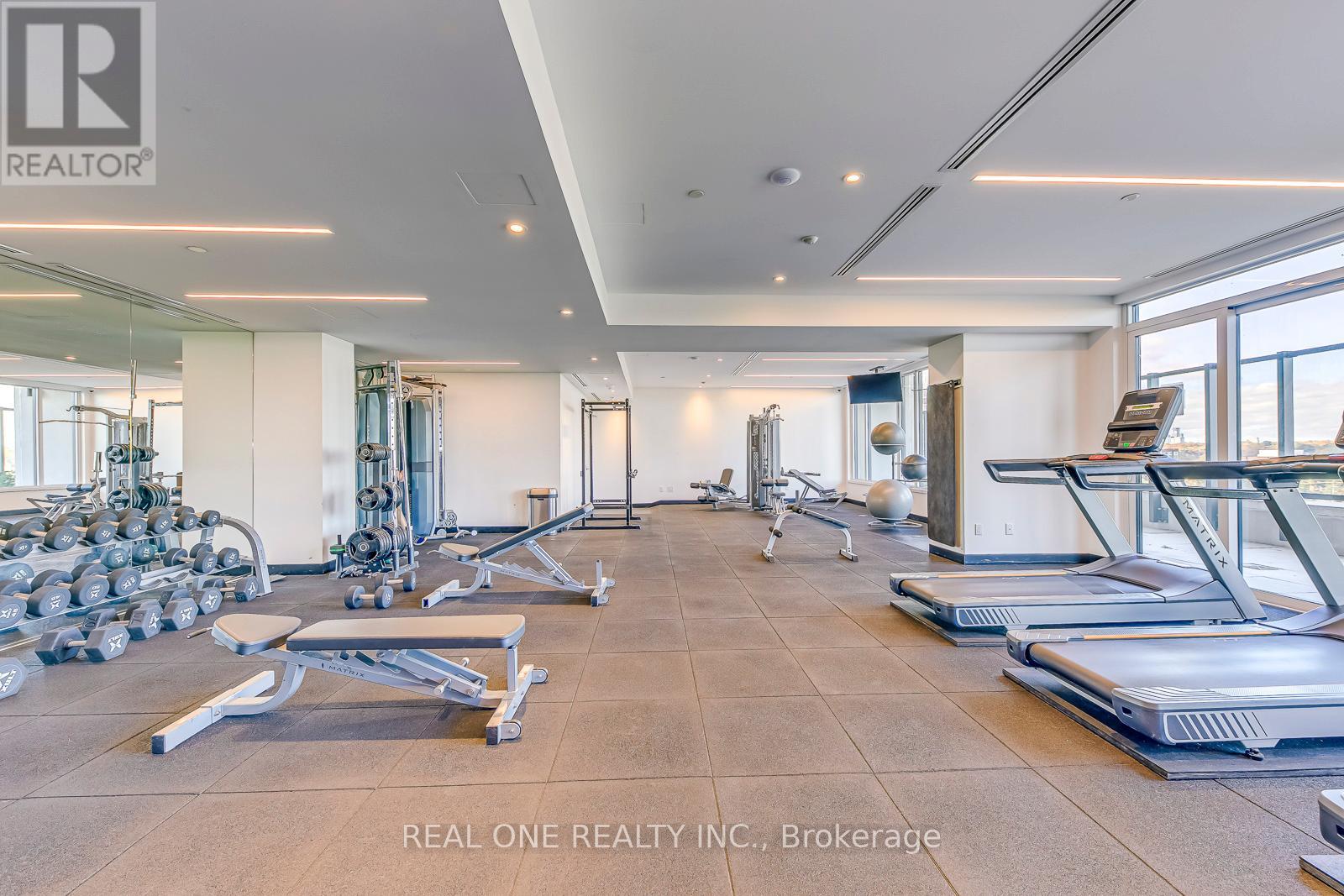 A gym with treadmills, weights, and exercise equipment.