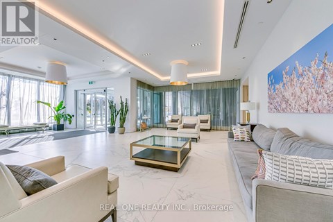 A spacious living room with a glass coffee table and a large painting on the wall.